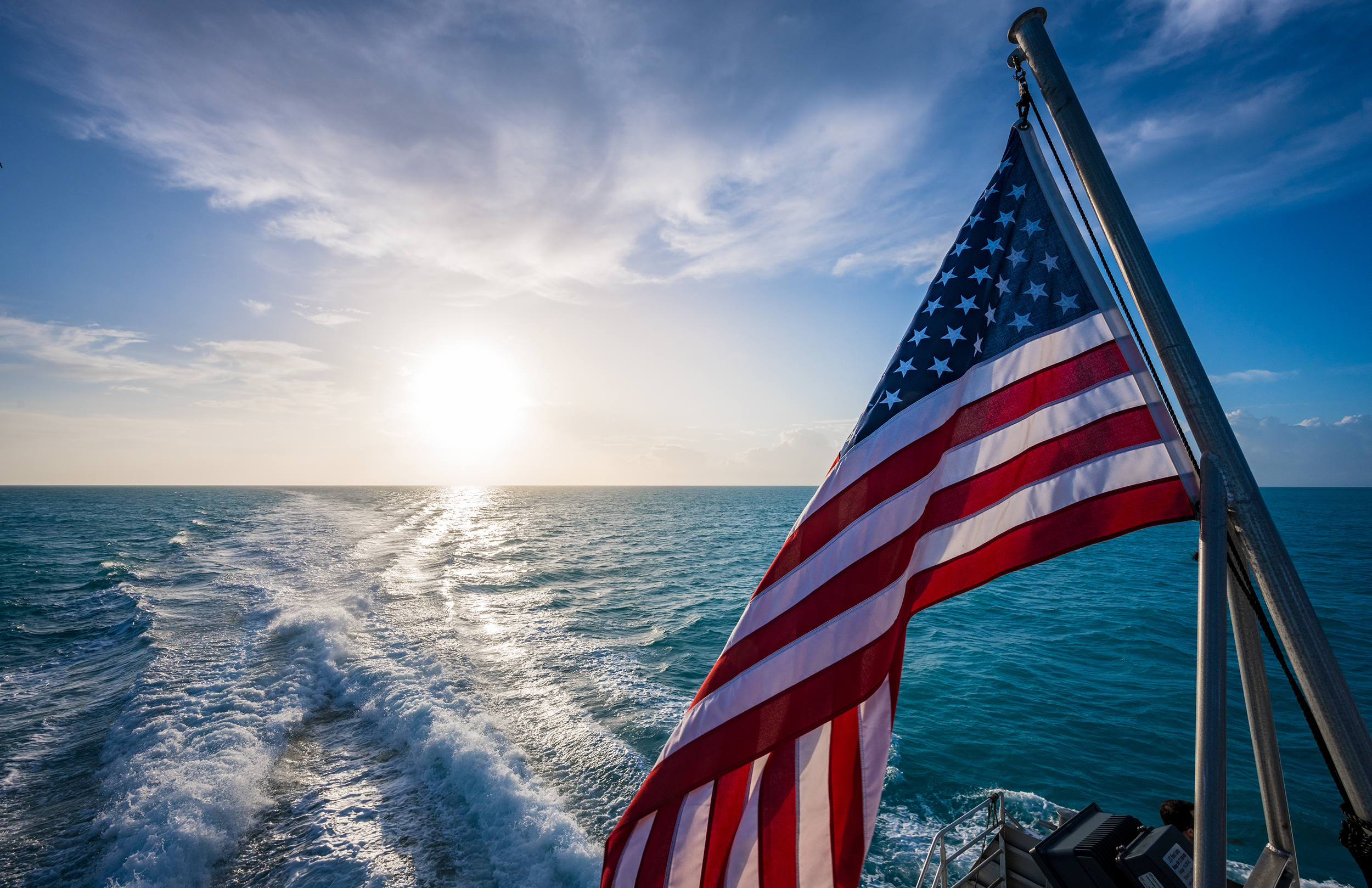 American Flag and Sunrise Over Gulf of Mexico on calm morning